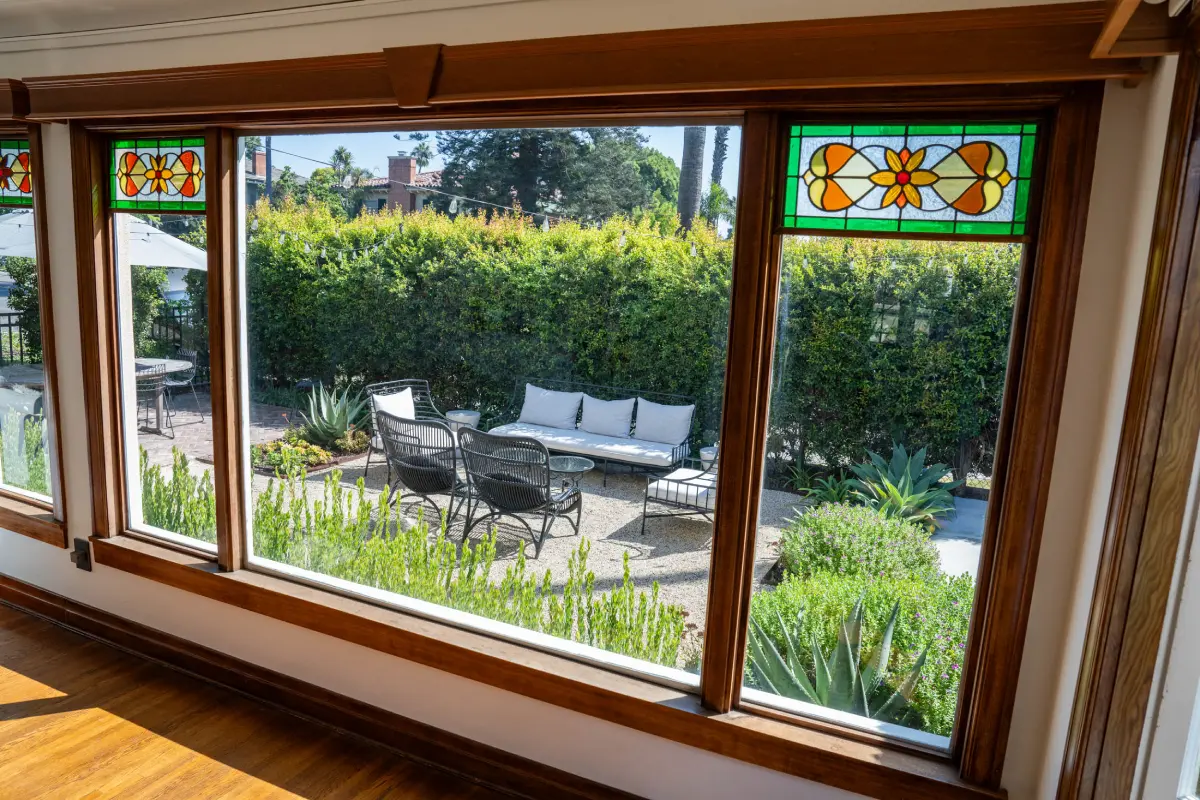 A patio with a couch and table in the middle of it