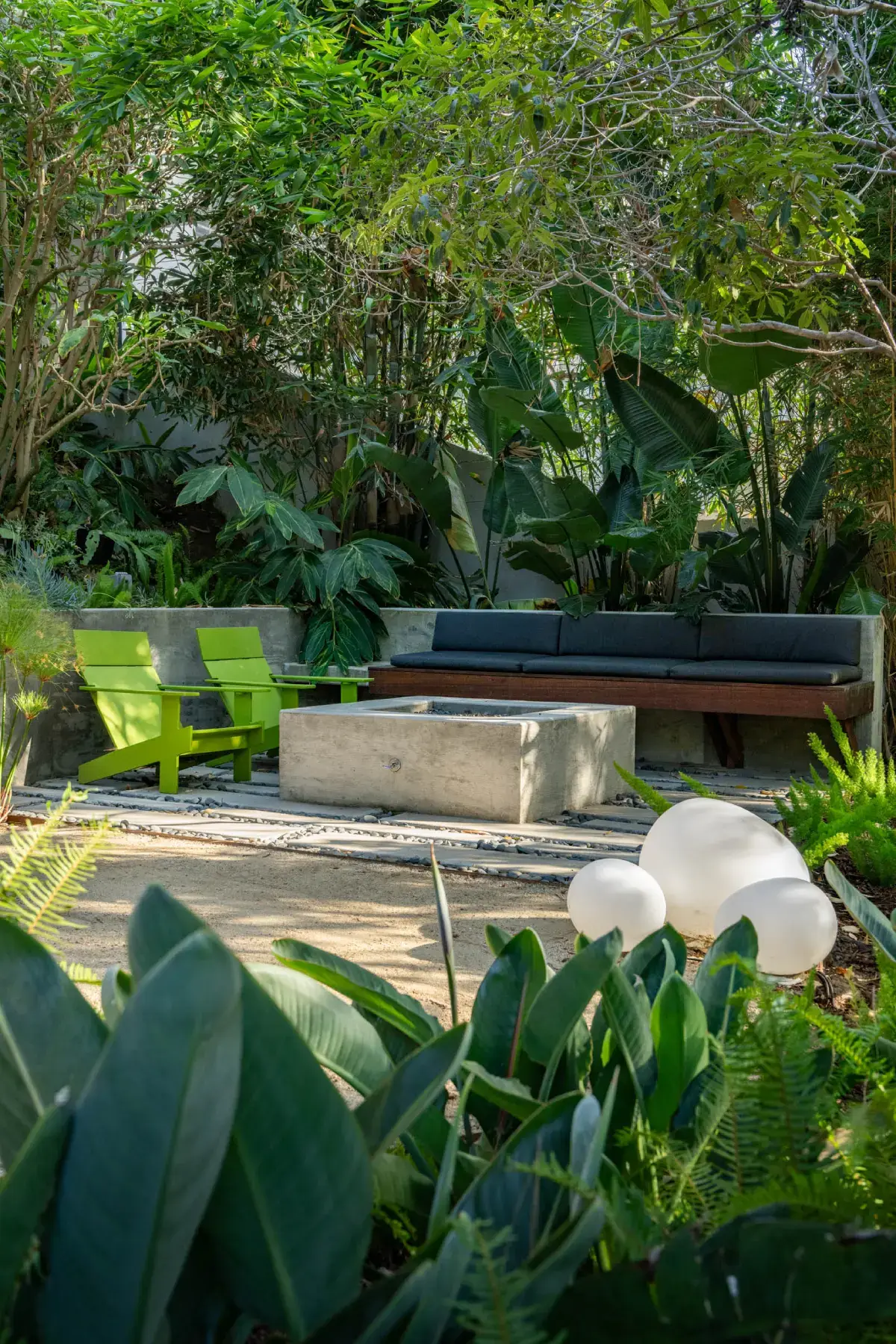 A garden with benches and plants in the background.