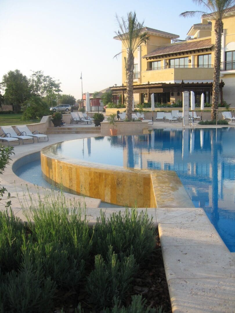 A pool with a bench and water slide in it
