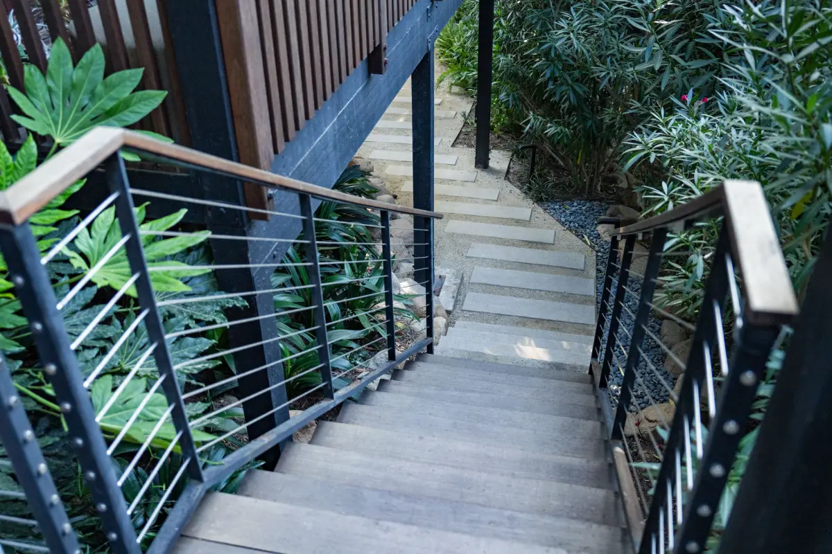A staircase with metal railing and steps leading to the top.