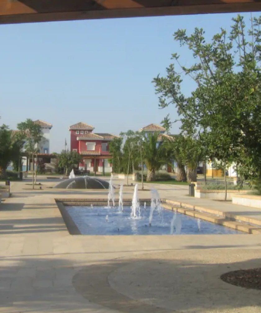 A fountain in the middle of a park.