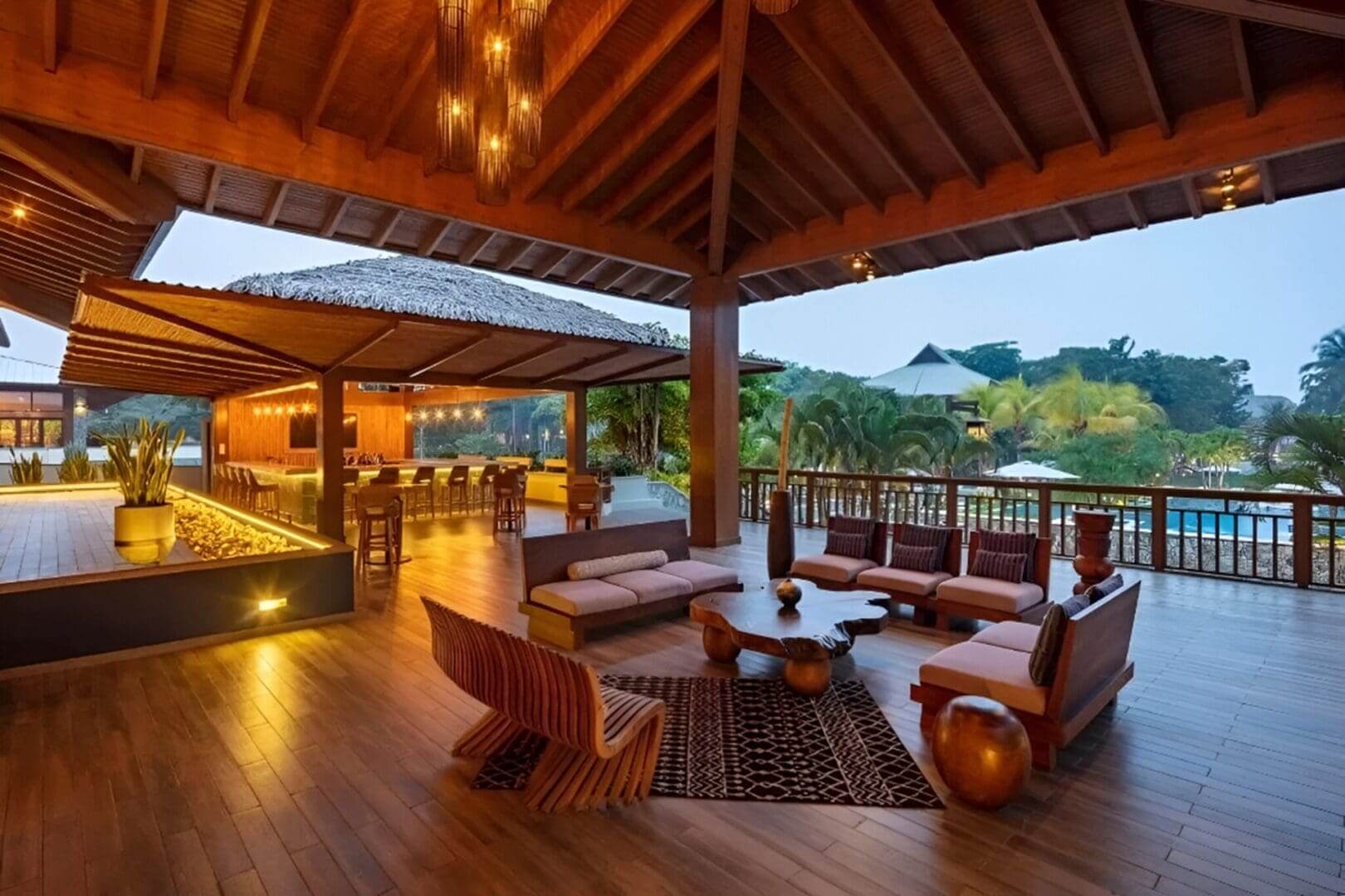 Outdoor lounge area with wooden furniture.