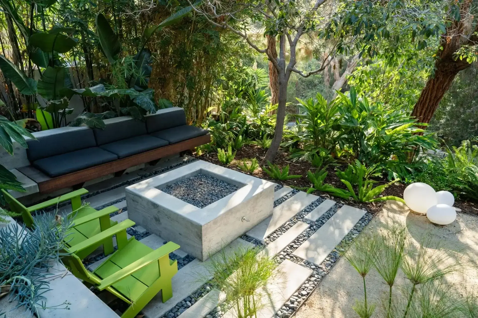 Modern garden patio with seating and fire pit.