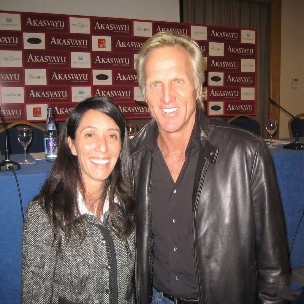 Man and woman smiling at an event.