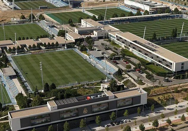 An aerial view of a soccer field with many trees.