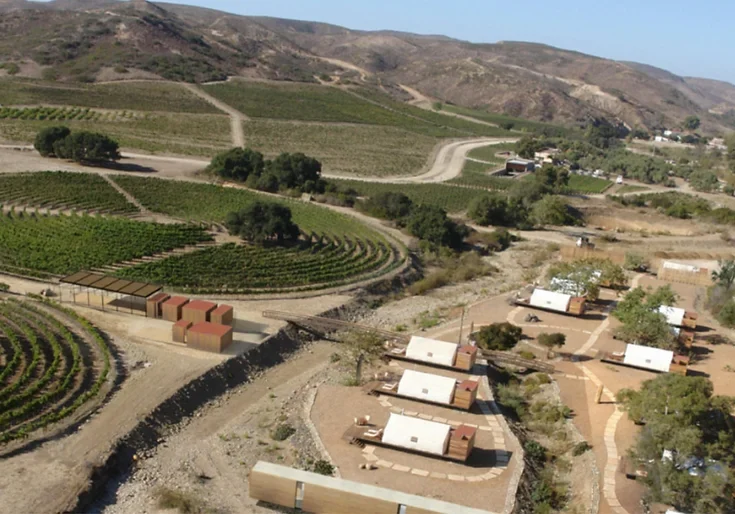 A view of some buildings and a field.