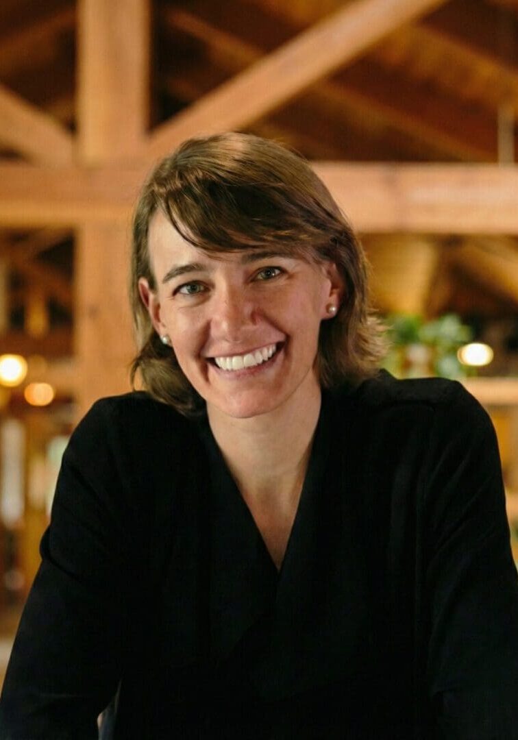 Smiling person in a wooden interior.